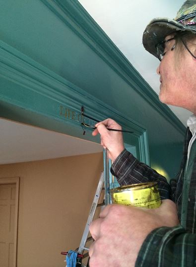 A Redec Decoration Conservator applies the final touches